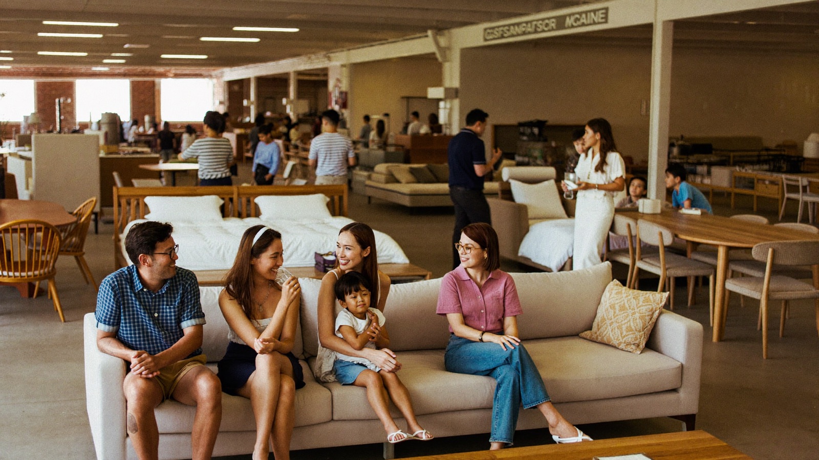 Visitors browsing furniture at a showroom event